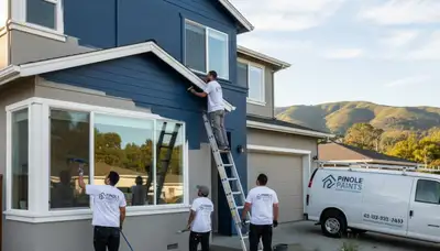 Professional house painters in Berkeley CA applying exterior paint to modern home façade